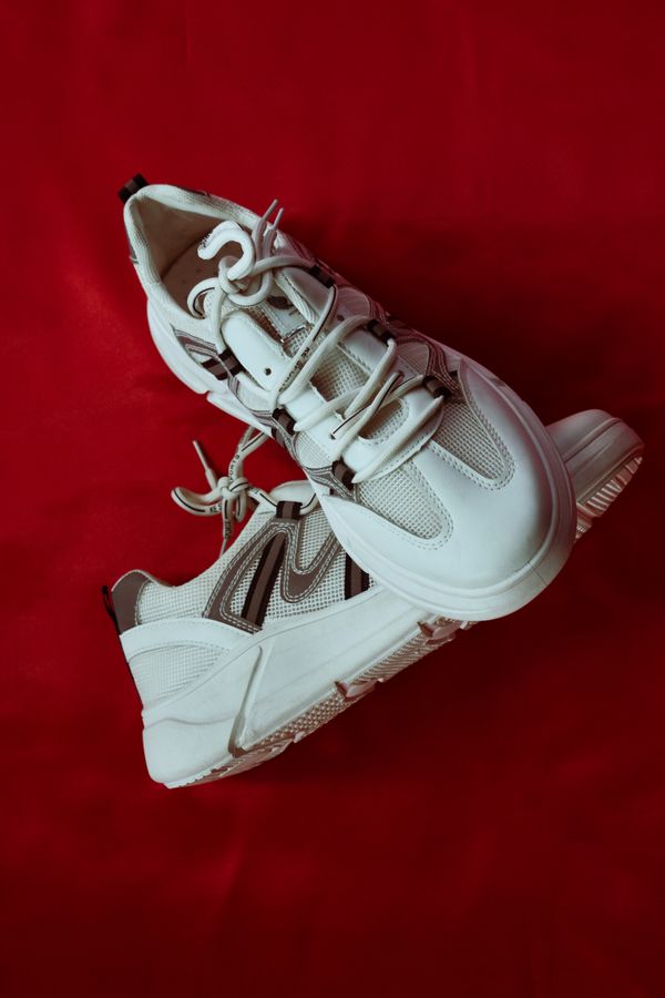 White chunky trainers on red fabric