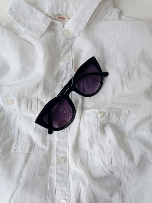 Black sunglasses on a white surface